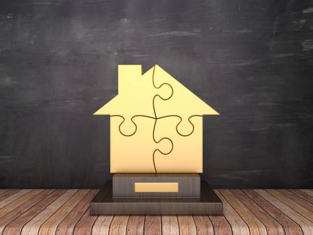 a house made out of puzzle on a wooden surface