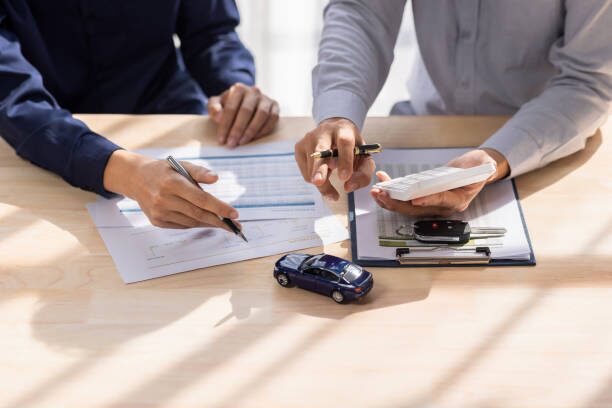 a photo showing two people talking about car insurance