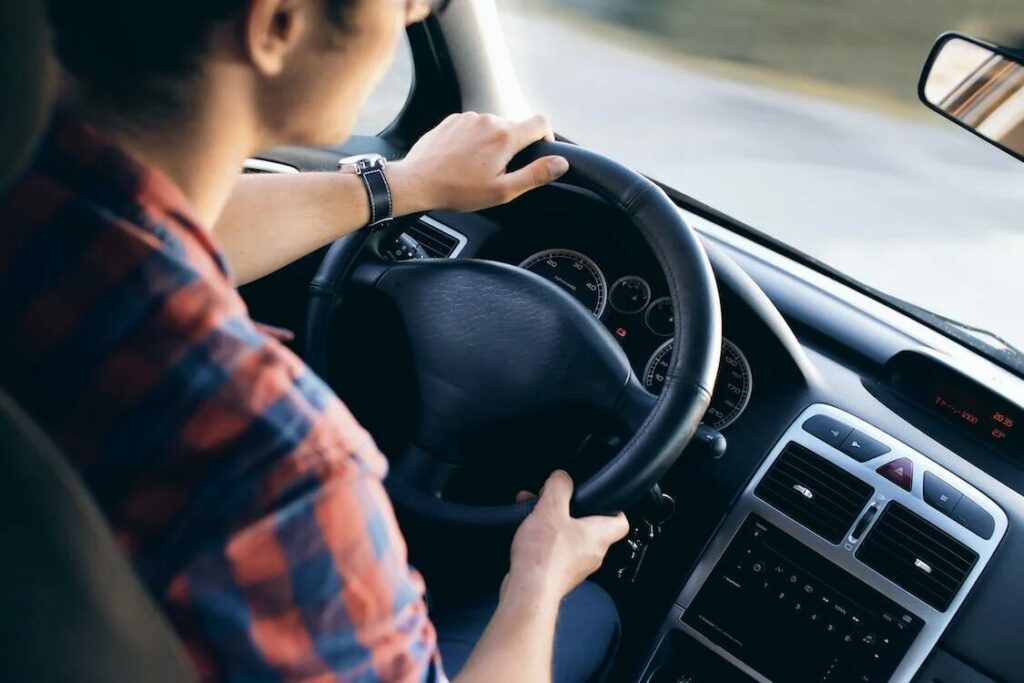 image of a man driving a car